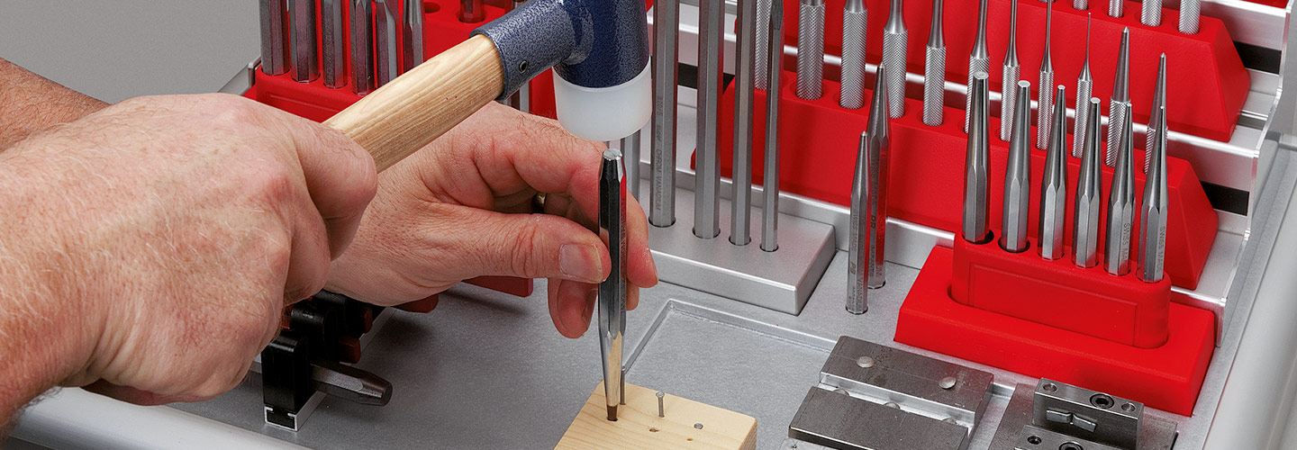 Precision PB Swiss punches and bits arranged on a workbench